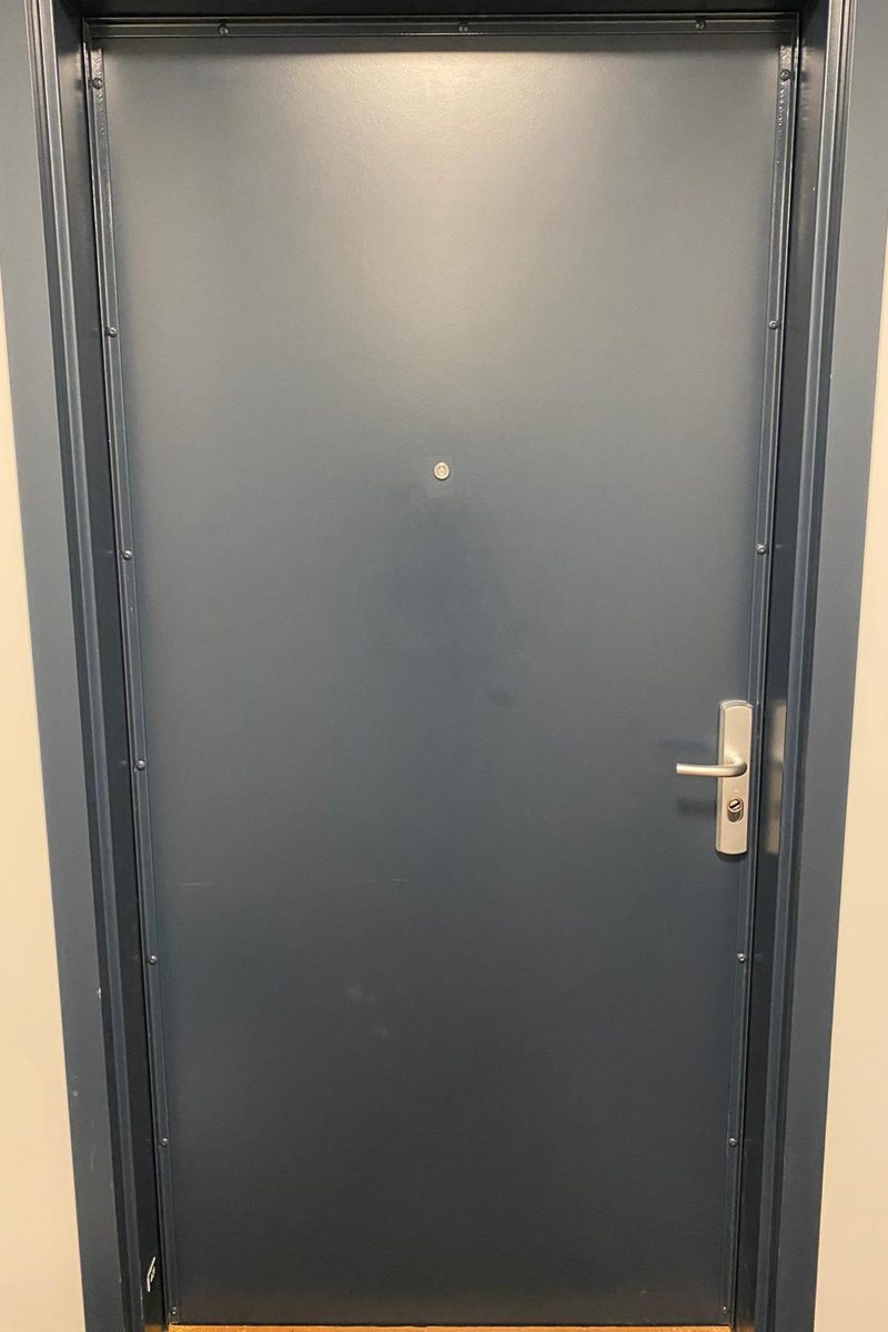 La même porte après la pose de cornières anti-pince sur tout le tour et d'une poignée blindée